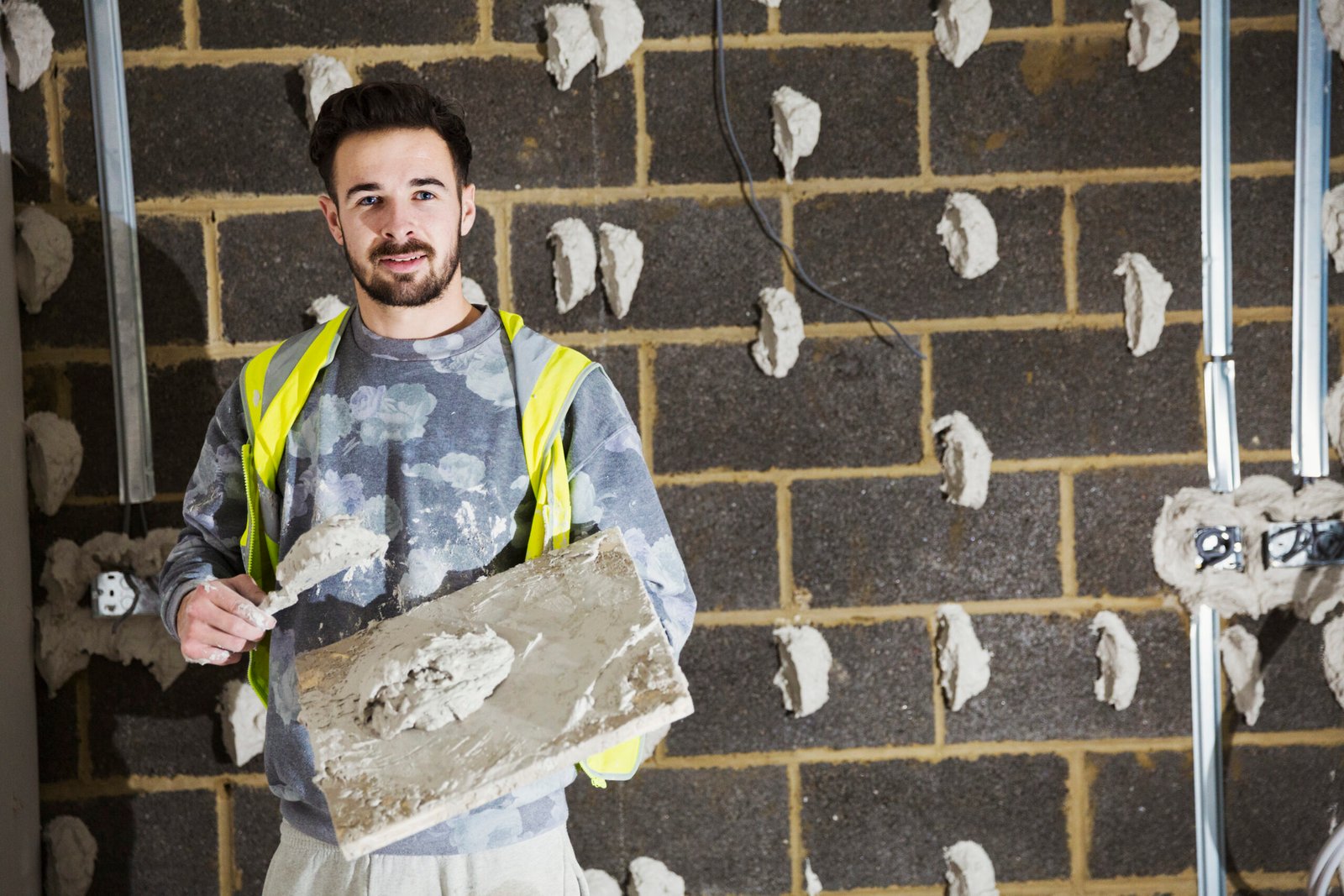 a plasterer a builder with plasterboard and sprea 2026 01 09 09 10 44 utc scaled First Frame Contracting